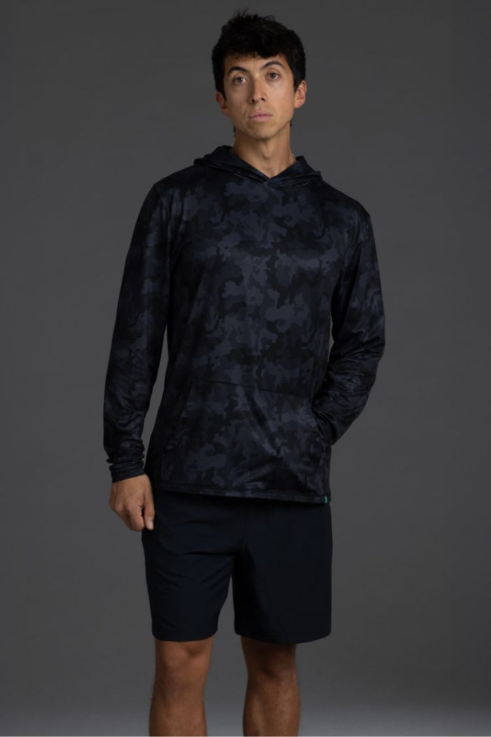 Person wearing a black camouflage hoodie and shorts on a gray background || Black Camo