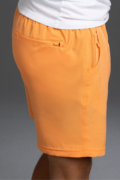 Orange shorts worn with a white shirt on a gray background || Light Orange