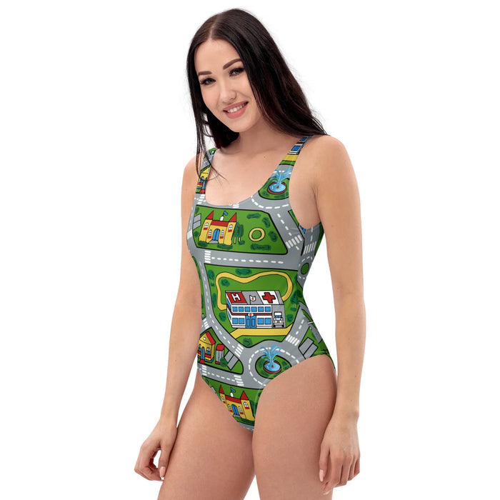 Car Carpet City One-Piece Swimsuit - The looping #999999 gray asphalt roads and the distinctive #FFFF00 yellow medieval castle contrasting against #4CAF50 turf green.
