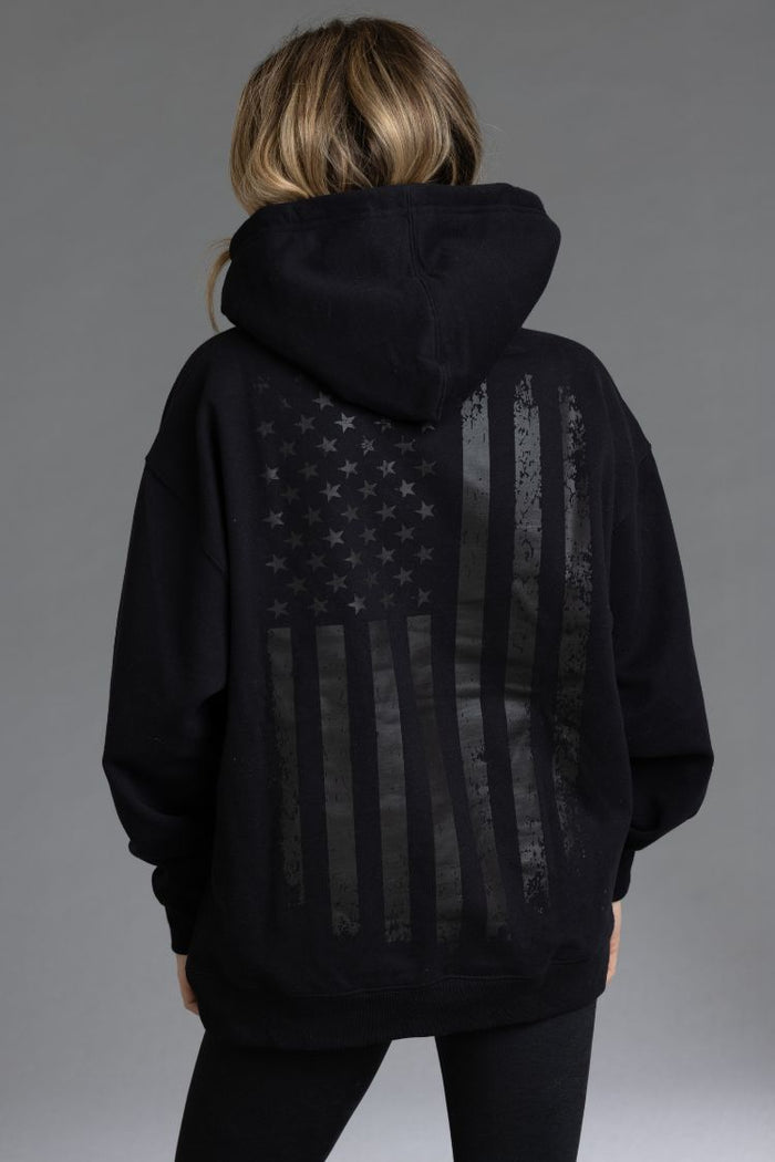 Person wearing a black hoodie with an American flag design || Black - Back Graphic