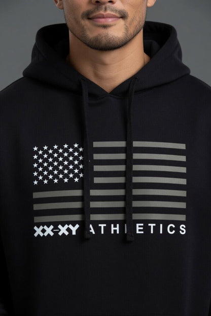 Person wearing a black hoodie with an American flag design and 'XXXY Athletics' text.  || Black