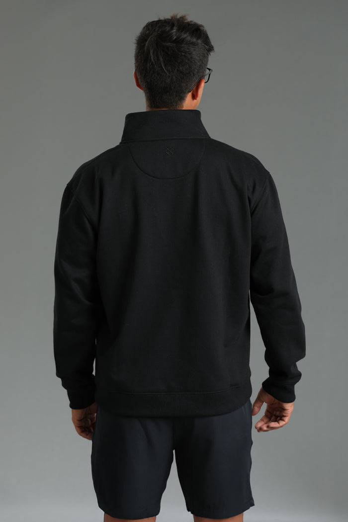 Person wearing a black jacket and shorts on a gray background || Black