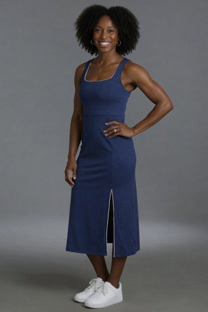 Woman wearing a blue dress with a gray background || Navy