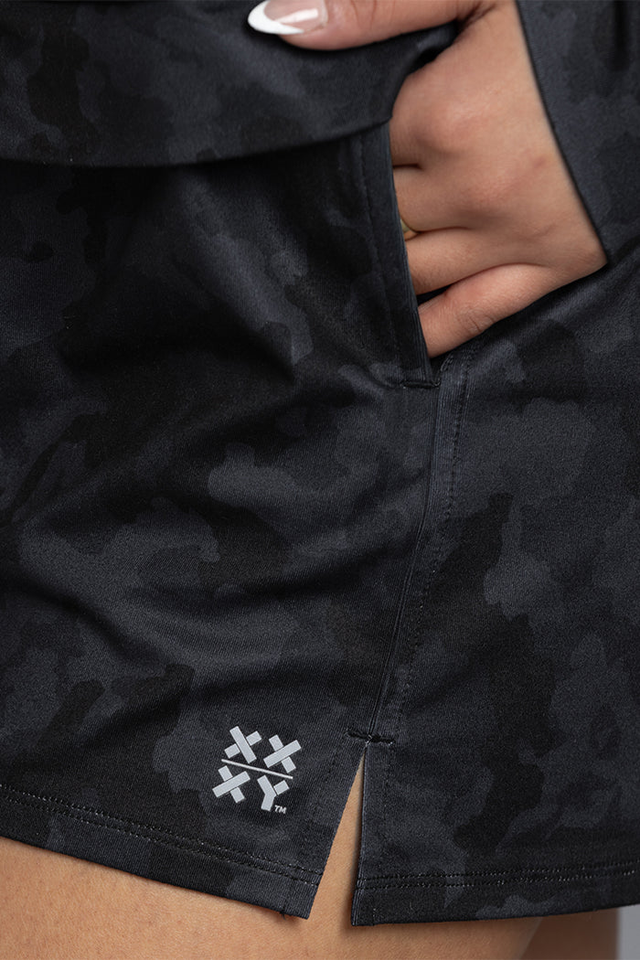 Black camouflage shorts with a brand logo on a neutral background || Black Camo